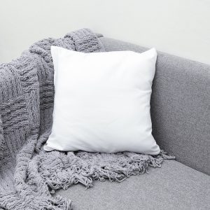 white throw pillow on gray sofa